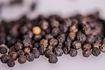 close up detail whole peppercorn on white background with low focus