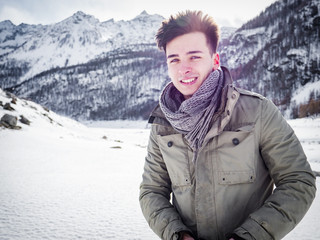 Young handsome man in winter sportswear looking away