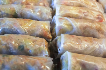 Closeup of pork spring rolls in rice wrappers
