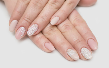 Manicure and white abstract pattern on women's nails