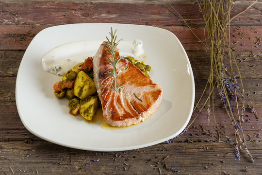 Tuna Steak with Fried Potatoes. On a wooden background. Top view. rustic food
