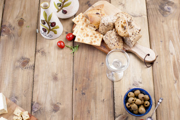 Bread, croutons, olives, a glass of white wine. Free space for text or advertising.