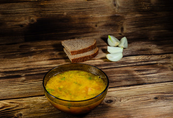 Vegetable soup in a glass bowl on wooden table