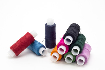 Colored thread on white background, sewing