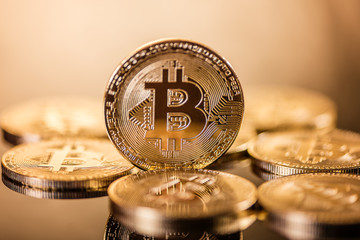gold bitcoin on golden background Cryptocurrency golden  electronic virtual money for web banking and international network payment, selective focus