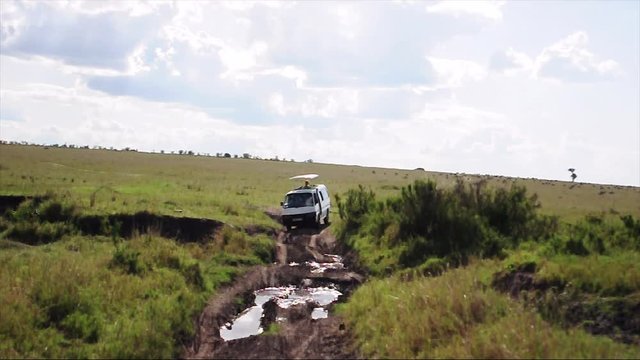 African Safari van driving through mudhole