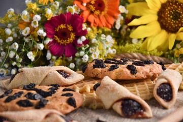 delicious cookies and waffles on a table on a background of flowers