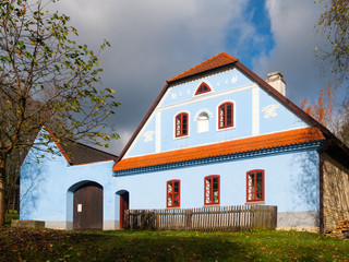 Rural farmhouse with blue facade. Vesely Kopec folk museum. Czech rural architecture. Vysocina, Czech Republic.