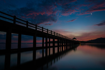 Fototapeta na wymiar The bridge in beautiful view on sea at sunrise