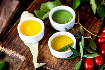 Oils, spices ahd herbs selection. Grape, olive and corn oils fresh herbs, lemons peppers. CSelective focus