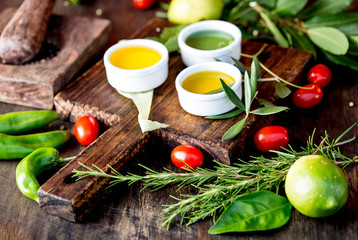 Oils, spices ahd herbs selection. Grape, olive and corn oils fresh herbs, lemons peppers. CSelective focus