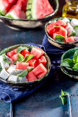 Watermelon cheese and mint salad with olive oil. Close up