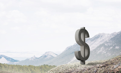 Money making and wealth concept presented by stone dollar symbol on natural landscape