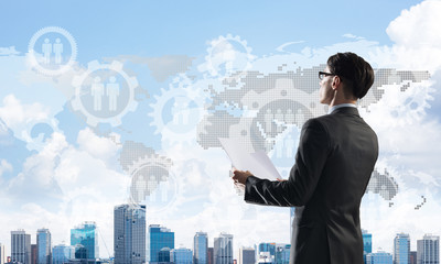 Concept of business success and control with confident boss against cityscape background