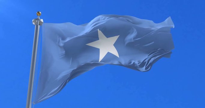 Flag of Somalia waving at wind in slow in blue sky, loop