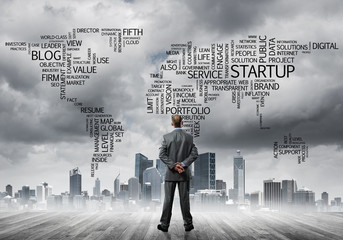 Motivation and inspiration concept with modern cityscape and businessman observing it
