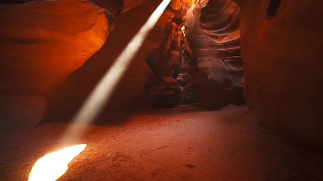 a tilt down shot of a floor to ceiling sun beam in upper antelope canyon in page, arizona