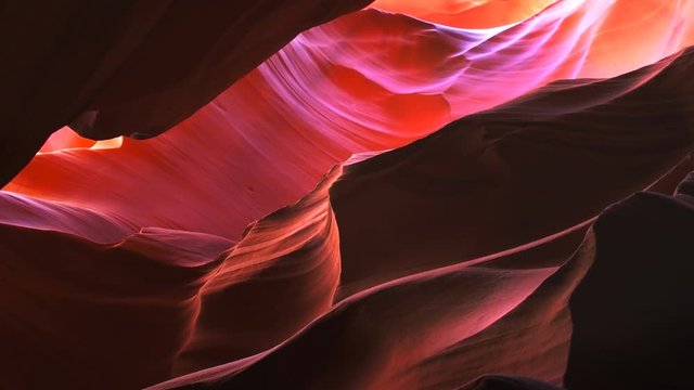 a pan right of a colorful sandstone rock wall in upper antelope canyon, arizona