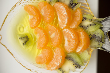 Jelly dessert with fruit. Slices of tangerine and kiwi.