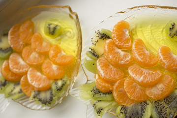 Jelly dessert with fruit. Slices of tangerine and kiwi.