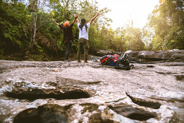 Lover women and men asians travel relax in the holiday. Walk in the forest. Relax on the rocks. stream dry waterfall caught hole Giants kettles. In thailand