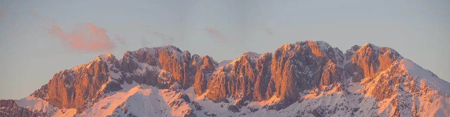 Foto op Canvas Presolana is a mountain range of the Orobie, Italian Alps. Landscape in winter. At sunset the rocks become red, orange and pink © Matteo Ceruti