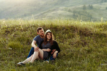 Naklejka na ściany i meble guy and girl are resting in the mountains, travel, camping, Valentine's, Europe, in love