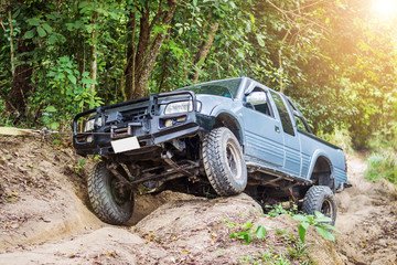 4 wheel drive is climbing on a difficult off-road in mountain forests in Thailand.