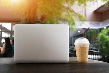 Laptop and coffee cup on wooden table, ?Business concept.