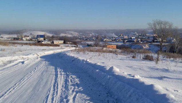 Winter Siberian village on a sunny day in a strong frost