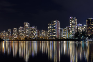 Fototapeta na wymiar Downtown Vancouver at night with water reflections.