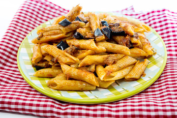 Spaghetti with aubergine and tomato sauce on a the table