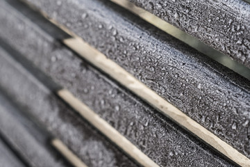 Diagonal wood logs with frozen water drops