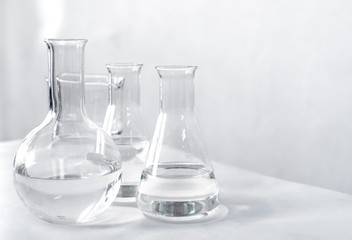 Science laboratory chemical beaker, Erlenmeyer and round flask lab glassware equipment. Research...