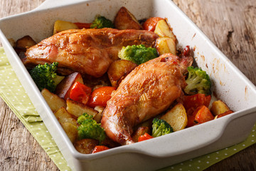 Organic healthy food: a baked rabbit with vegetables close-up in a baking dish on a table. horizontal