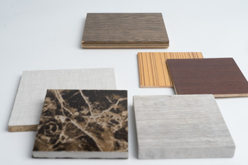 samples of material, wood , color ,ceramic , on wooden table on white background .Interior design select material for idea.