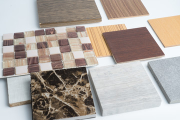 samples of material, wood , color ,ceramic , on wooden table on white background .Interior design select material for idea.