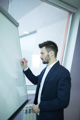 Young business man in front of white board