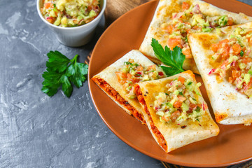 Traditional Mexican dish - chimichanga. Corn cake with minced meat, pepper, onion, garlic, oregano, zira and guacomole sauce from avocado.