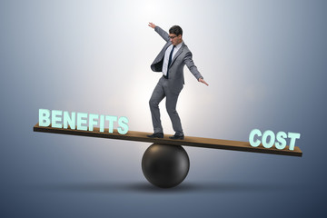 Businessman balancing between cost and benefit in business conce