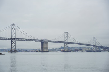 Fototapeta na wymiar The beautiful San Francisco Oakland Bay Bridge in a cloudy day