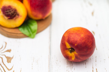 Fototapeta na wymiar a lot of fresh peaches on a white table.