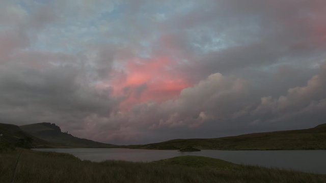 Sunset over mountain Old Man Storr over lake in Scotland, time-lapse