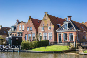 Fototapeta na wymiar Historic houses at a canal in Hindeloopen