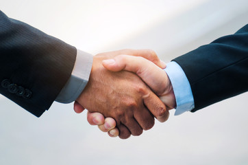 close up of business man in suit handshake after finishing up a business meeting in the city, congratulation, success, meeting, partner, teamwork, community and connection concept, selective focus