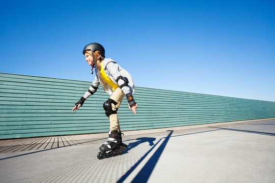 Boy rollerblading in helmet and protective gear