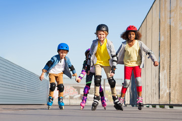 Plakat Boys and girls rollerblading at stadium outdoors