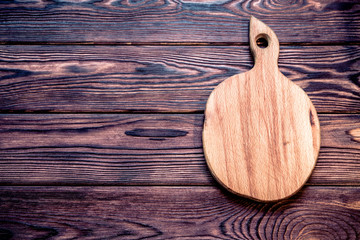 cutting board lies on a wooden background