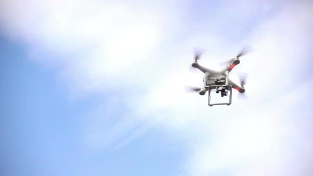 Drone flying in the sky. Flight and rotation of propellers in slow motion.