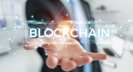 Businessman using blockchain cryptocurrency interface 3D rendering